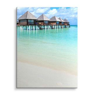 Wandbild mit tropischem Meer, Pfahlbauten und türkisblauem Wasser auf Leinwand